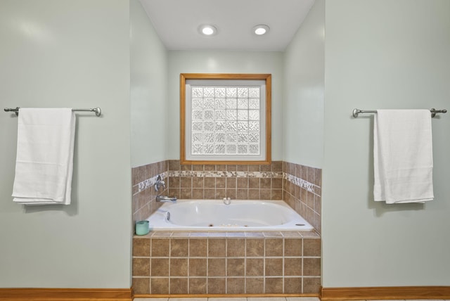 bathroom featuring tiled tub