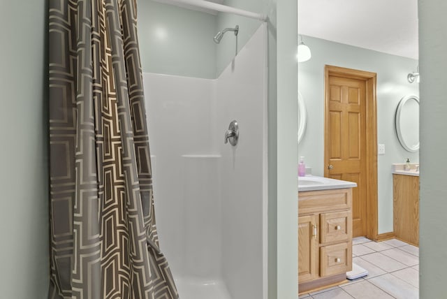 bathroom featuring tile patterned flooring, vanity, and curtained shower