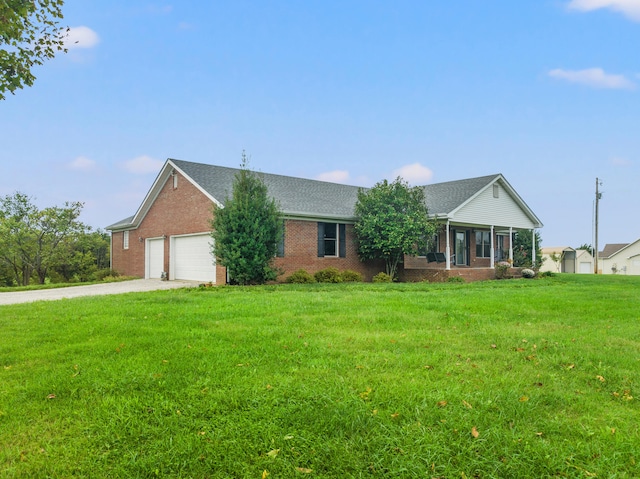 single story home featuring a garage, a sunroom, and a front lawn