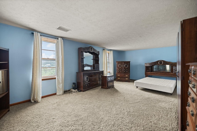 carpeted bedroom with a textured ceiling