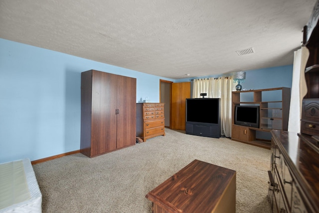 living room featuring light carpet and a textured ceiling