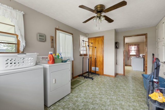 washroom with a healthy amount of sunlight, washer and dryer, and ceiling fan