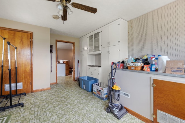 interior space with ceiling fan