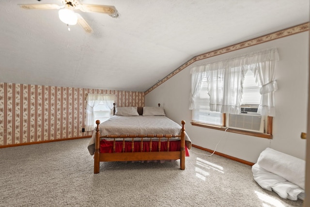 carpeted bedroom with a textured ceiling, cooling unit, lofted ceiling, and ceiling fan