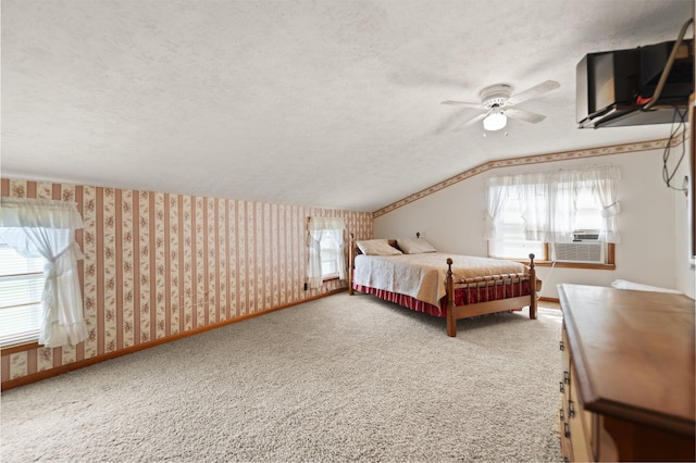 bedroom featuring ceiling fan, a textured ceiling, lofted ceiling, and carpet