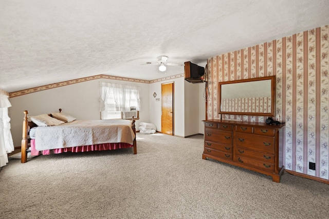 bedroom with ceiling fan, carpet flooring, and a textured ceiling