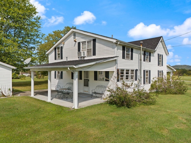 rear view of house with a patio area and a yard