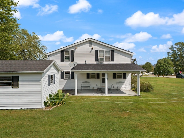 rear view of house featuring a patio area and a yard