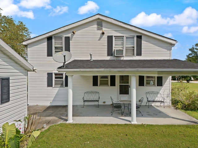 back of house featuring cooling unit, a lawn, and a patio