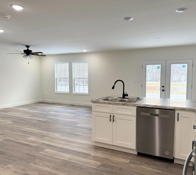 kitchen with white cabinets, stainless steel dishwasher, ceiling fan, and sink