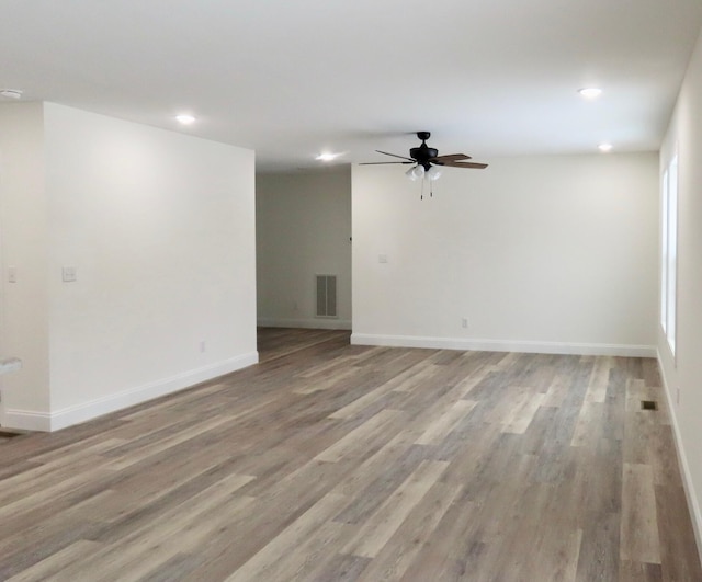 spare room with ceiling fan and light wood-type flooring