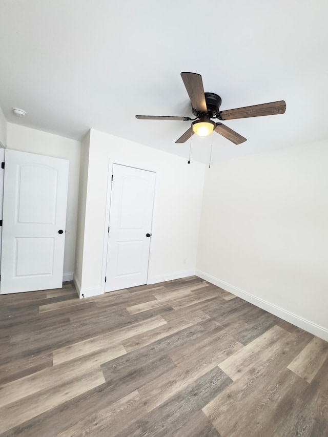 unfurnished room featuring hardwood / wood-style floors and ceiling fan