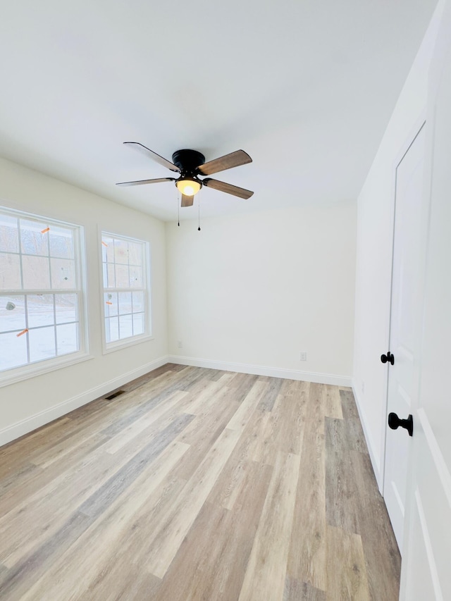 spare room with light hardwood / wood-style flooring and ceiling fan