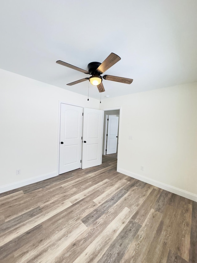 unfurnished room featuring hardwood / wood-style floors and ceiling fan