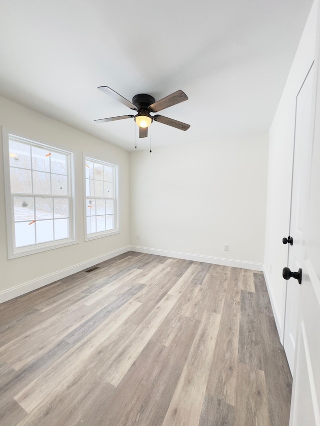 unfurnished room featuring light hardwood / wood-style flooring and ceiling fan