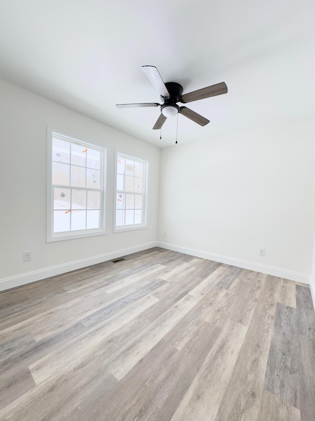 unfurnished room featuring ceiling fan and light hardwood / wood-style floors