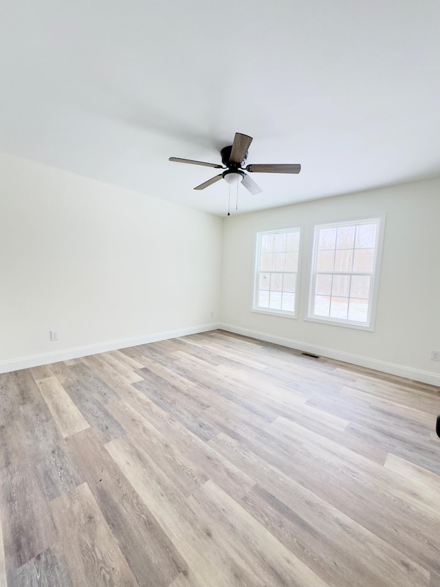 spare room featuring light wood-type flooring and ceiling fan