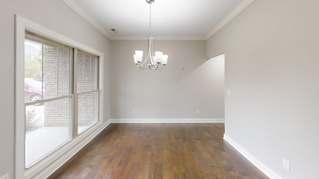 unfurnished dining area featuring a healthy amount of sunlight, crown molding, dark hardwood / wood-style floors, and a chandelier