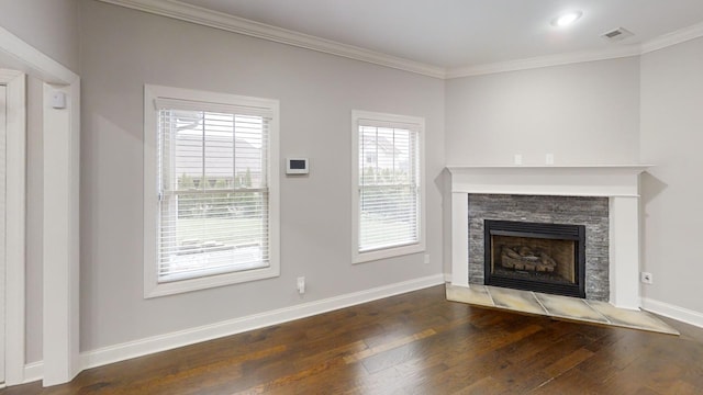 unfurnished living room featuring a stone fireplace, dark hardwood / wood-style floors, and crown molding