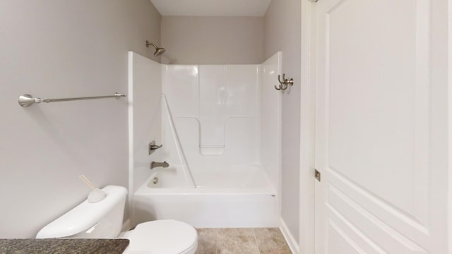 bathroom featuring bathing tub / shower combination and toilet