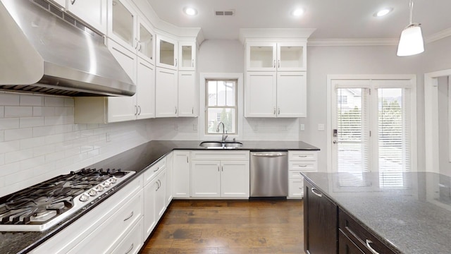 kitchen with dark stone counters, dark hardwood / wood-style flooring, appliances with stainless steel finishes, and sink