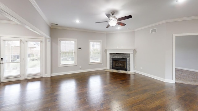 unfurnished living room featuring ceiling fan, dark hardwood / wood-style floors, a fireplace, and crown molding