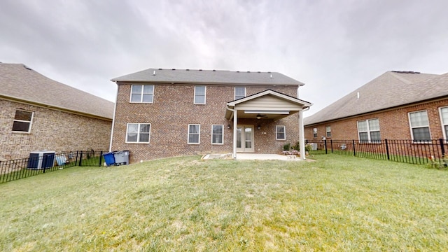 back of house with central AC unit, a lawn, and a patio area