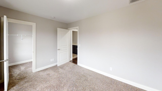 unfurnished bedroom with carpet floors and a closet