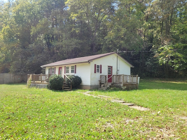 view of front of house with a wooden deck and a front yard