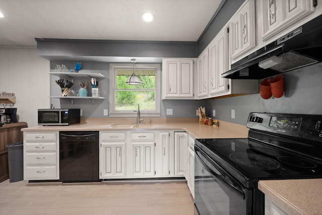 kitchen with sink, decorative light fixtures, white cabinetry, ventilation hood, and black appliances