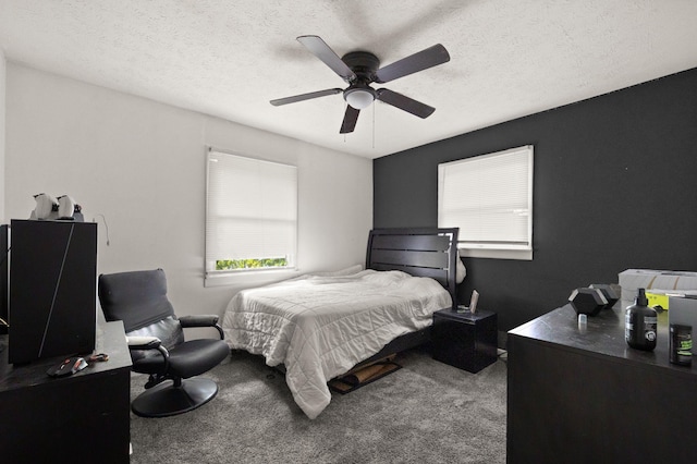 carpeted bedroom featuring a textured ceiling and ceiling fan