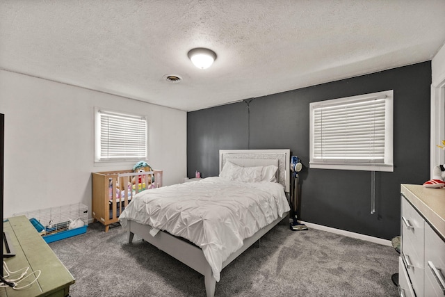 bedroom featuring a textured ceiling and carpet