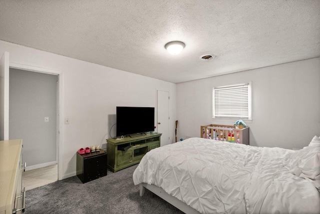 carpeted bedroom with a textured ceiling