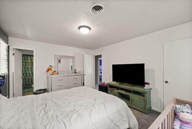 bedroom with a textured ceiling and carpet flooring