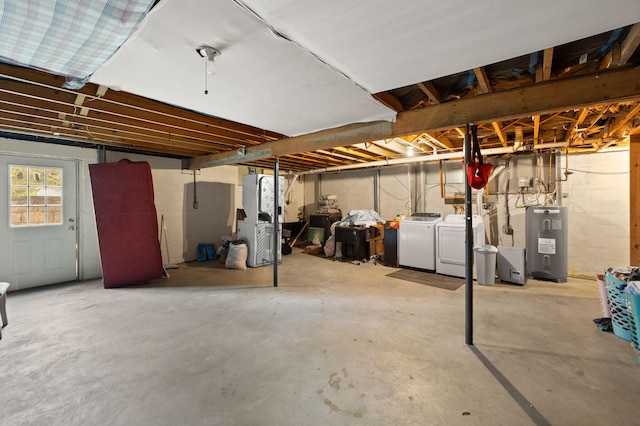 basement featuring water heater and washing machine and dryer