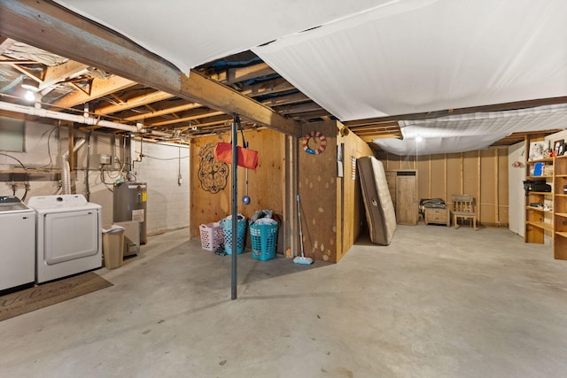 basement featuring water heater and independent washer and dryer