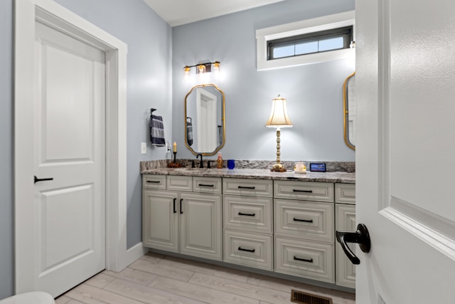 bathroom with vanity and hardwood / wood-style flooring