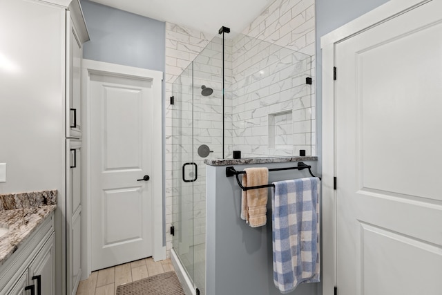 bathroom featuring vanity and an enclosed shower