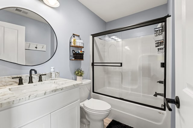 full bathroom featuring vanity, toilet, and enclosed tub / shower combo