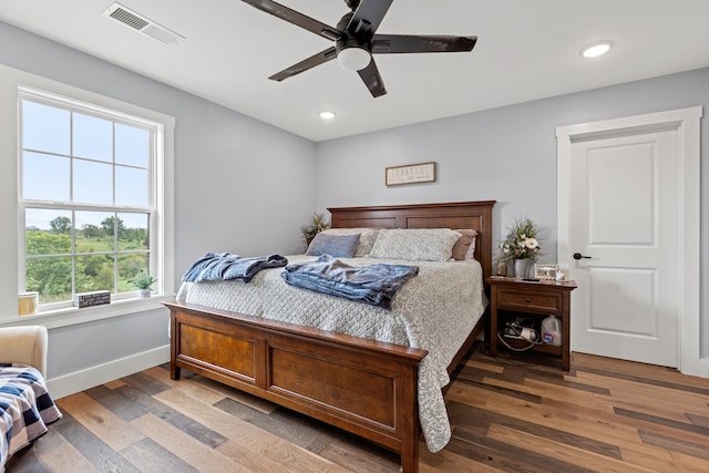 bedroom with wood-type flooring and ceiling fan