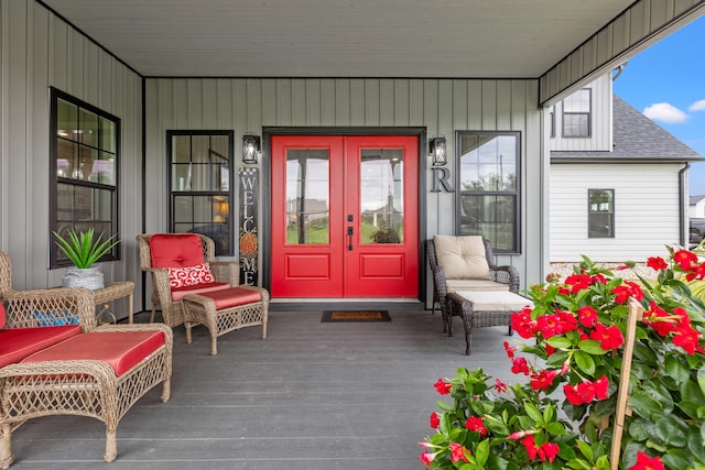 entrance to property featuring a porch and french doors