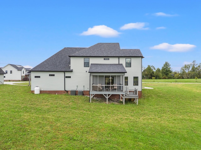 rear view of property with a yard, cooling unit, and a sunroom