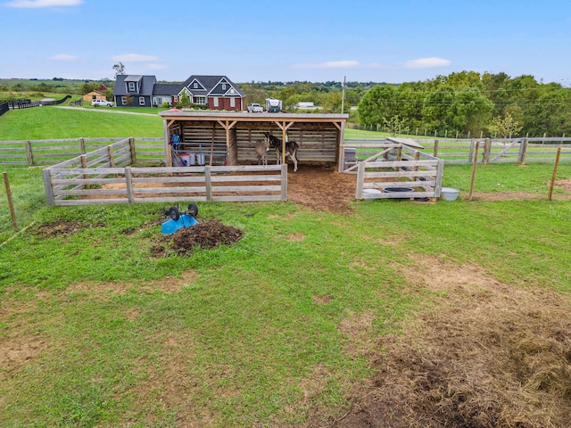 view of yard with an outbuilding and a rural view