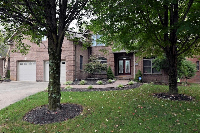 view of property hidden behind natural elements featuring a front lawn and a garage