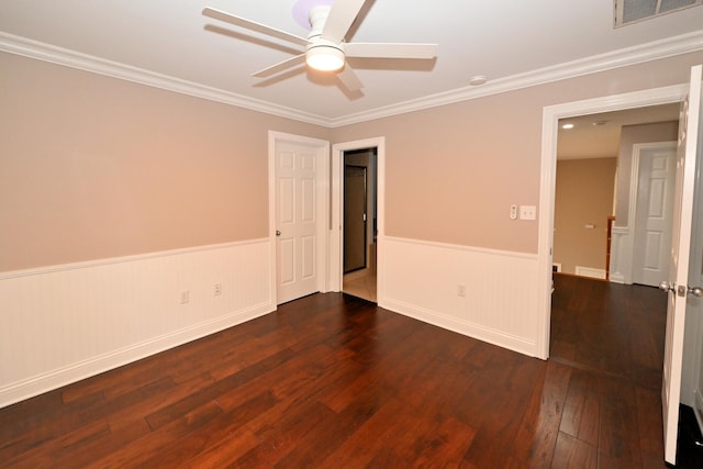 unfurnished dining area with dark wood-type flooring and crown molding