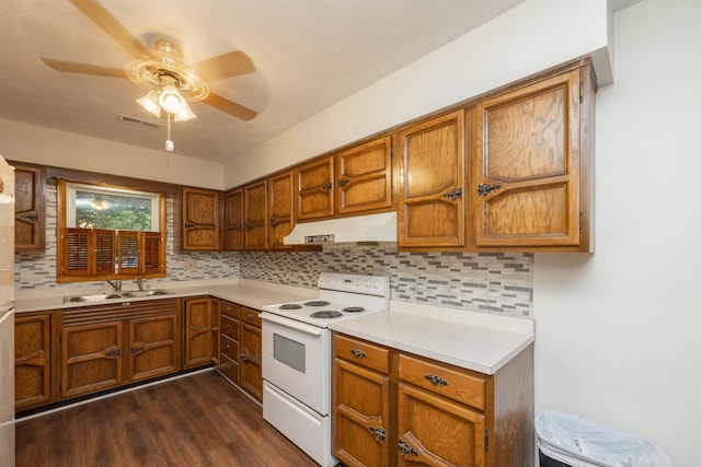 kitchen featuring decorative backsplash, dark hardwood / wood-style floors, white electric stove, and sink