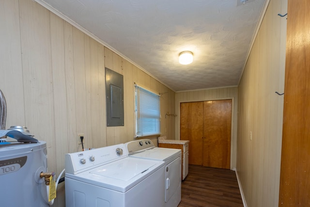 laundry area featuring electric water heater, dark hardwood / wood-style flooring, electric panel, wood walls, and washer and dryer