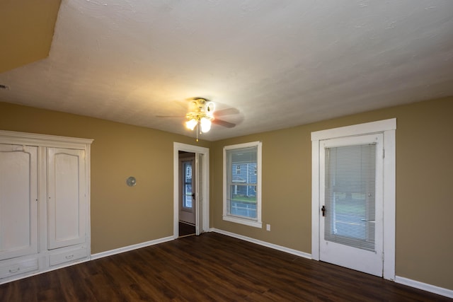 interior space with dark hardwood / wood-style floors and ceiling fan