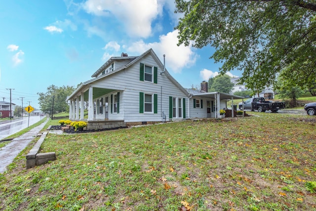 back of house with a porch and a yard