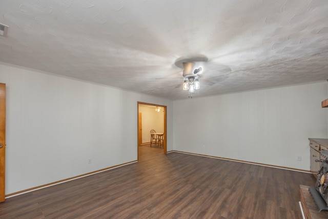 spare room with a textured ceiling and dark wood-type flooring